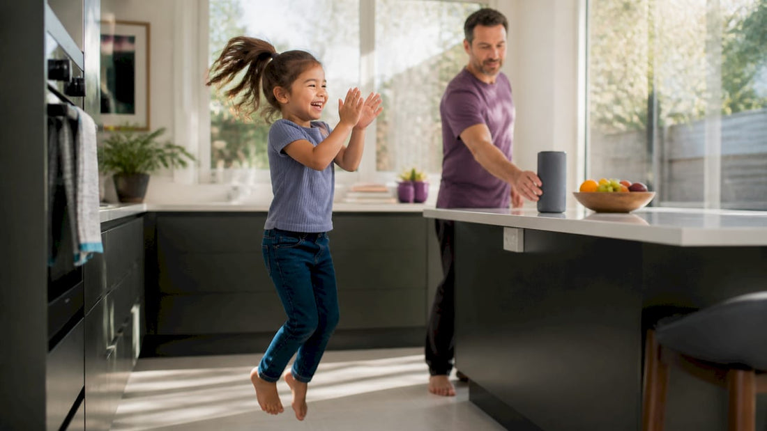 Parent placing smart speaker near child clapping