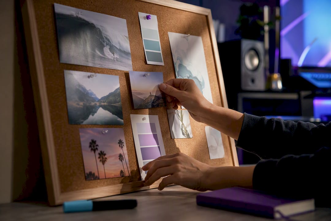Hands arranging a focused vision board collage