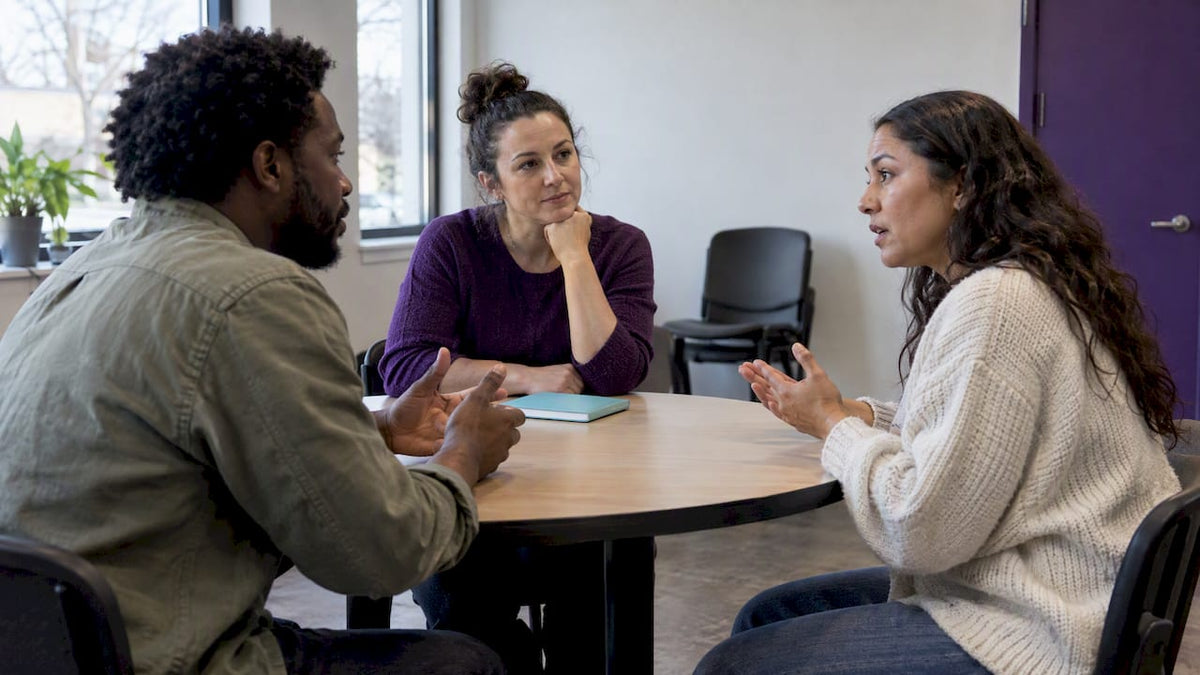 Neutral facilitator guiding a calm conversation