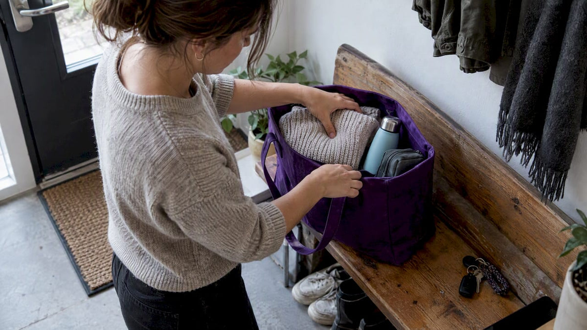 Traveler packing a tote bag for flight