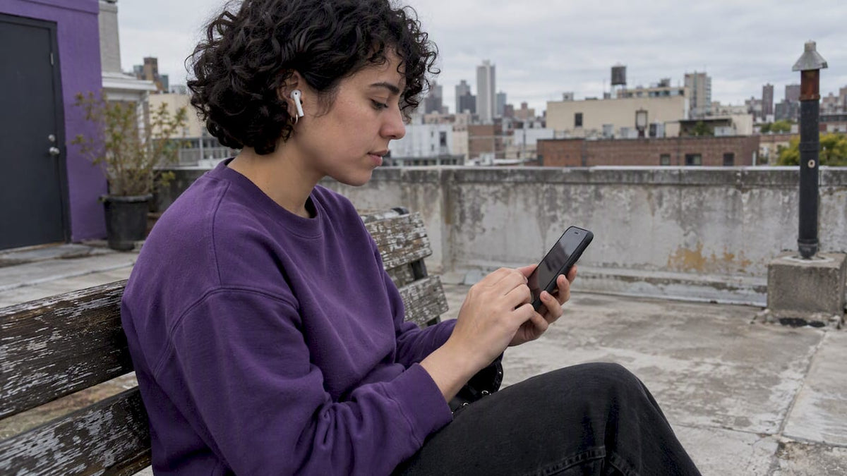 Person choosing songs on a rooftop terrace