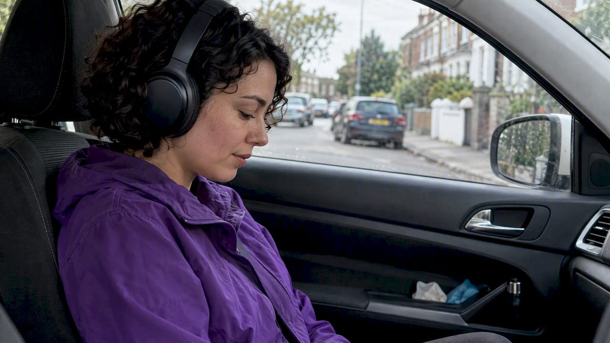 Woman listening quietly in a parked car