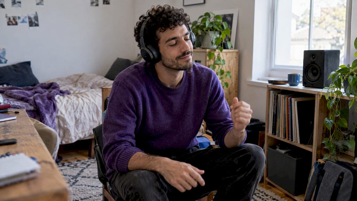 Man humming along to music at home