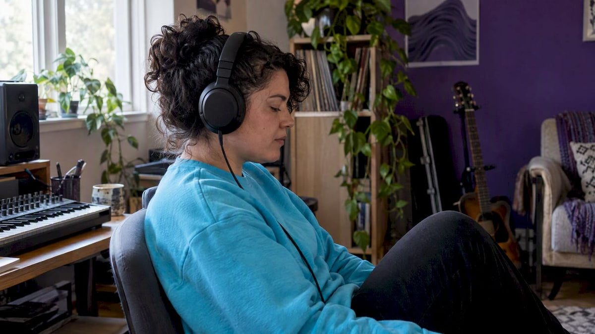 Woman listening intently through headphones