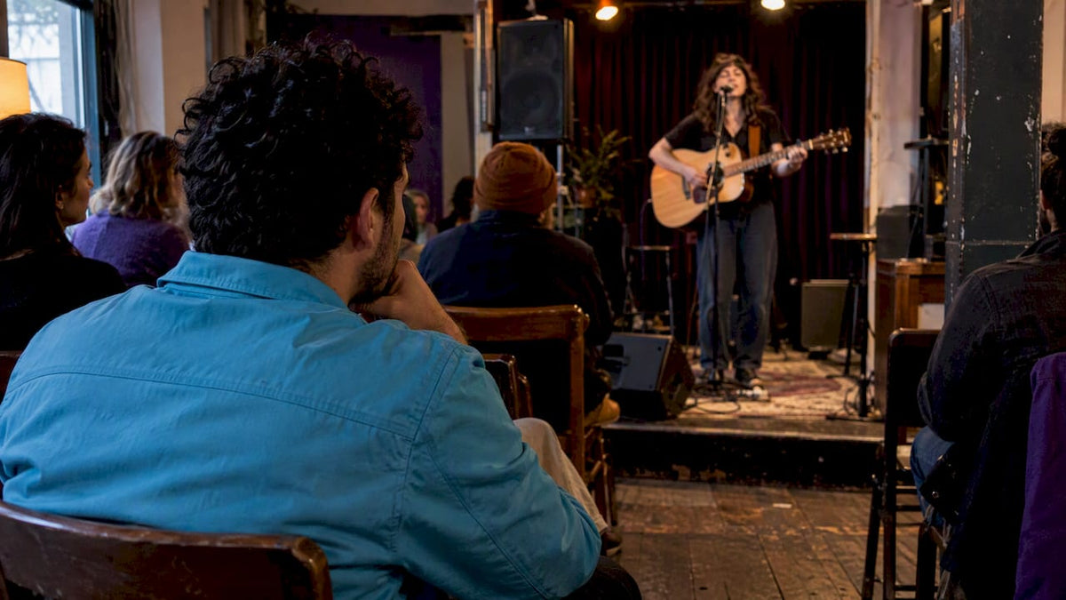 Listener discovering a song at an open mic